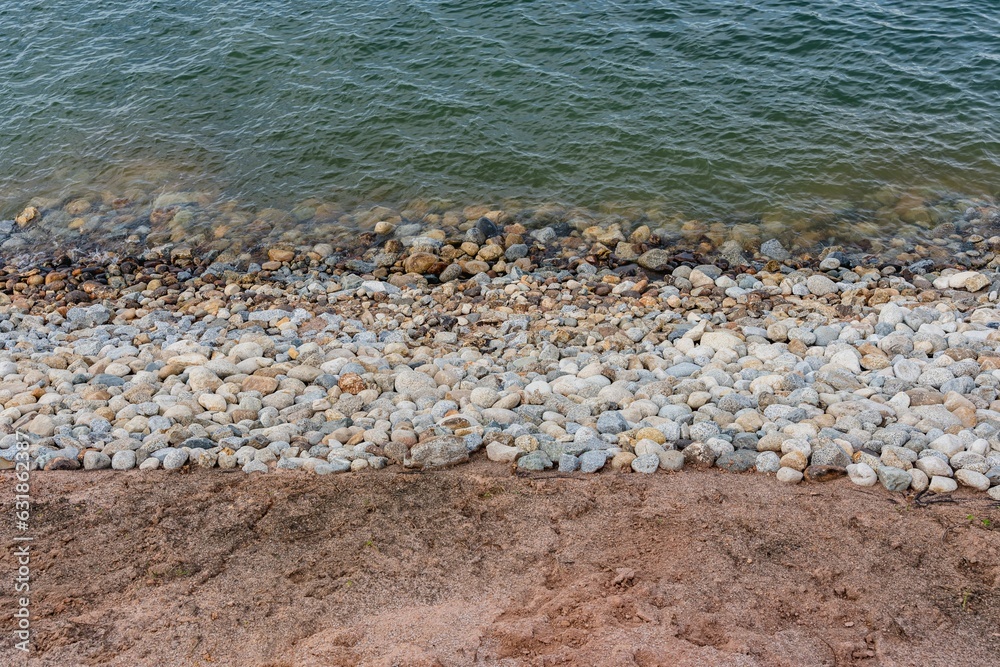Tranquil beachfront view of a rocky shoreline situated along a picturesque cliff Tranquil beachfront view of a rocky shoreline situated along a picturesque cliff