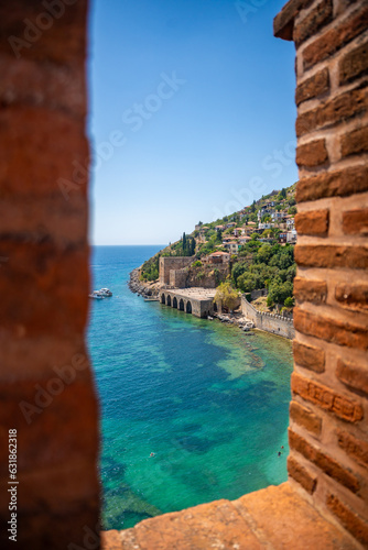 Fototapeta Naklejka Na Ścianę i Meble -  Ancient shipyard or Tersane near of Kizil Kule tower and beautiful beach and calm turquoise sea surface in Alanya, Turkey