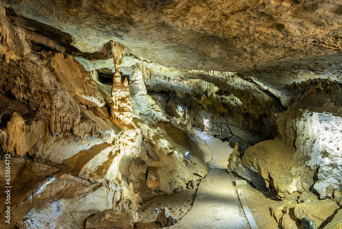 open public area of underground cave network in Belgium Ardennes called Les Grottes de Remouchamps where tourists can explore the subterranean world with impressive geological rock formations  photo