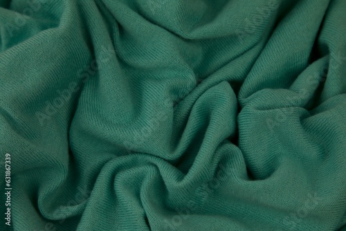 Closeup shot of green fabric with folds.