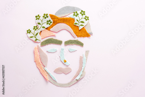 Fototapeta Naklejka Na Ścianę i Meble -  Creative concept of portrait a female face from textile waste on a pink background. Ecological and sustainable fashion. Recycling and reduce fashion waste concept. flay lay. top view