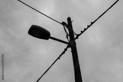 A concrete electricity pole with a rainy sky © Luka Šper