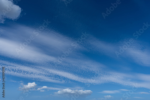 bautiful blue sky with some cumuls and cirrocumulus clouds photo