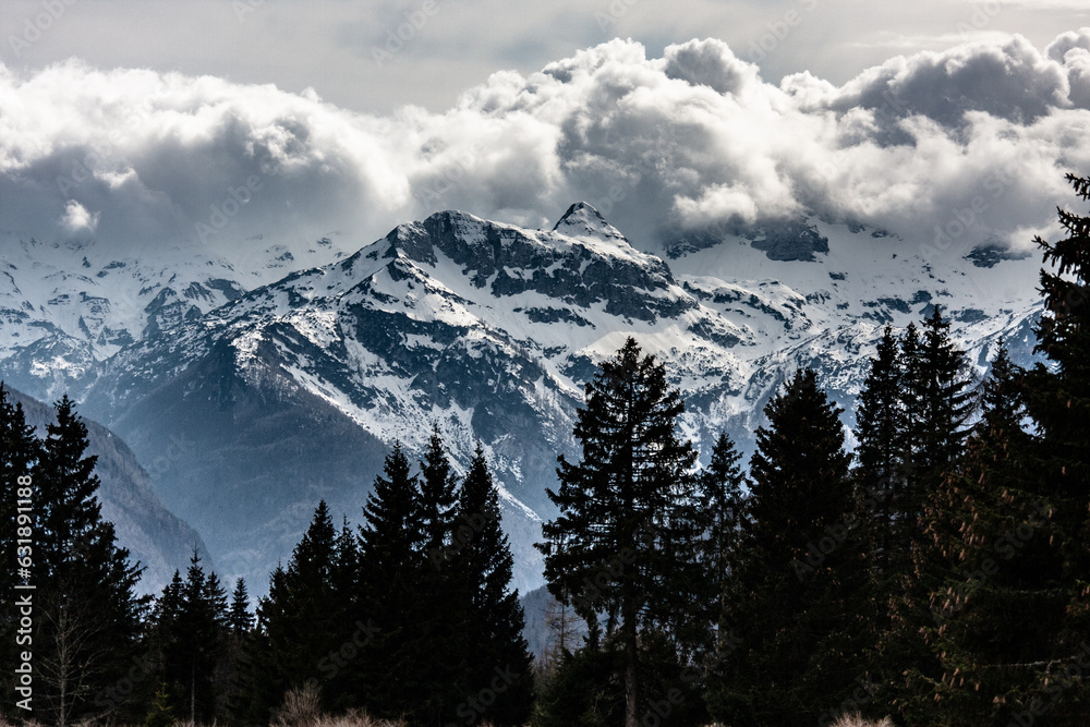 snow covered mountains with heavy cluods