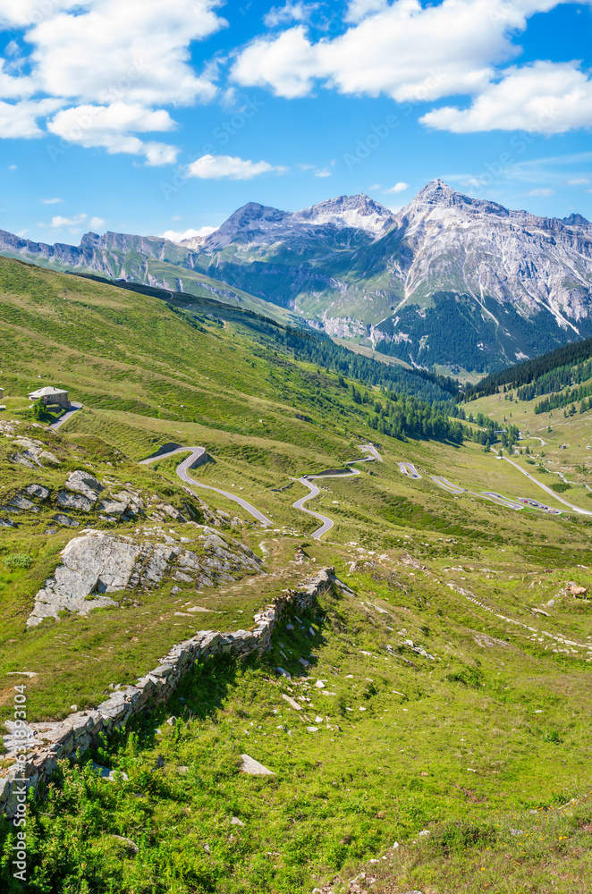 Landscape panoramic view of Splugen mountain pass in Switzerland and its alpine road with tight serpentines as well as the old road. Landscape panoramic view of Splugen mountain pass in Switzerland and its alpine road with tight serpentines as well as the old road.