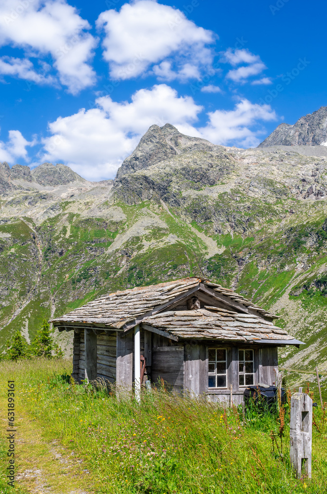 Wooden shepherd hut at the Splugenpass - Passo Spluga mountain pass between Italy and Switzerland