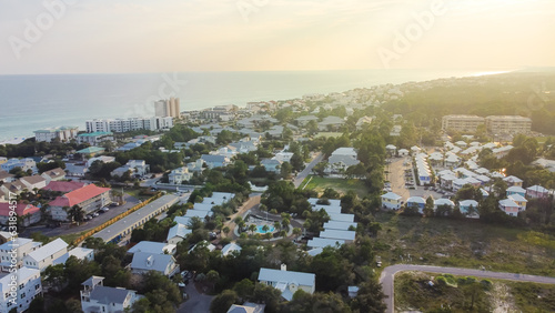 Sunset over Seagrove beach neighborhood with row of white painted vacation homes, condo buildings, residential units along county road 30A spanning 2 miles Gulf shoreline, Santa Rosa, Florida photo