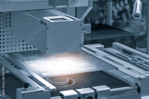 Photography Close up of examining of test sample of microchip transistor under the microscope in laboratory