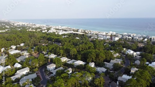 Beach waterfront view along county road 30A spanning 2 miles Gulf shoreline in Seagrove neighborhood row of white painted multistory vacation rental homes, condo building, Santa Rosa, Florida photo