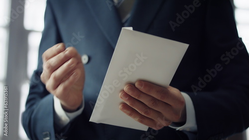 Hands holding bribe envelope containing euro cash close up. Financial crime. photo