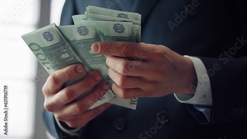 Closeup hands calculating banknotes euro. Man counting european currency cash.