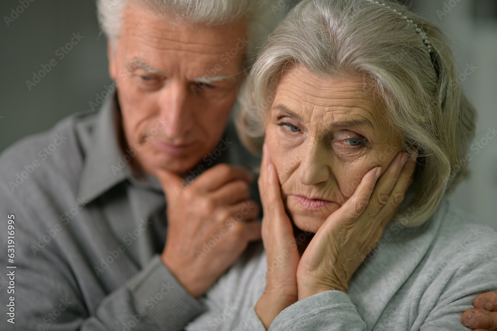 Close up portrait of sad senior couple posing at home Close up portrait of sad senior couple posing at home