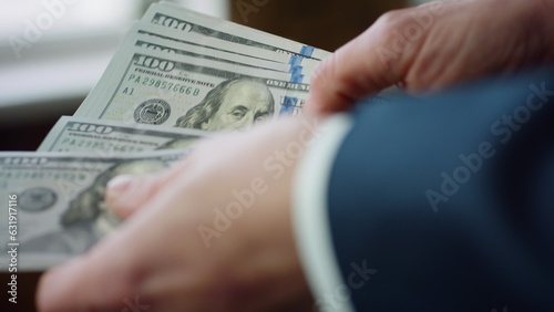 Banker hands counting american currency denomination of hundred dollars close up