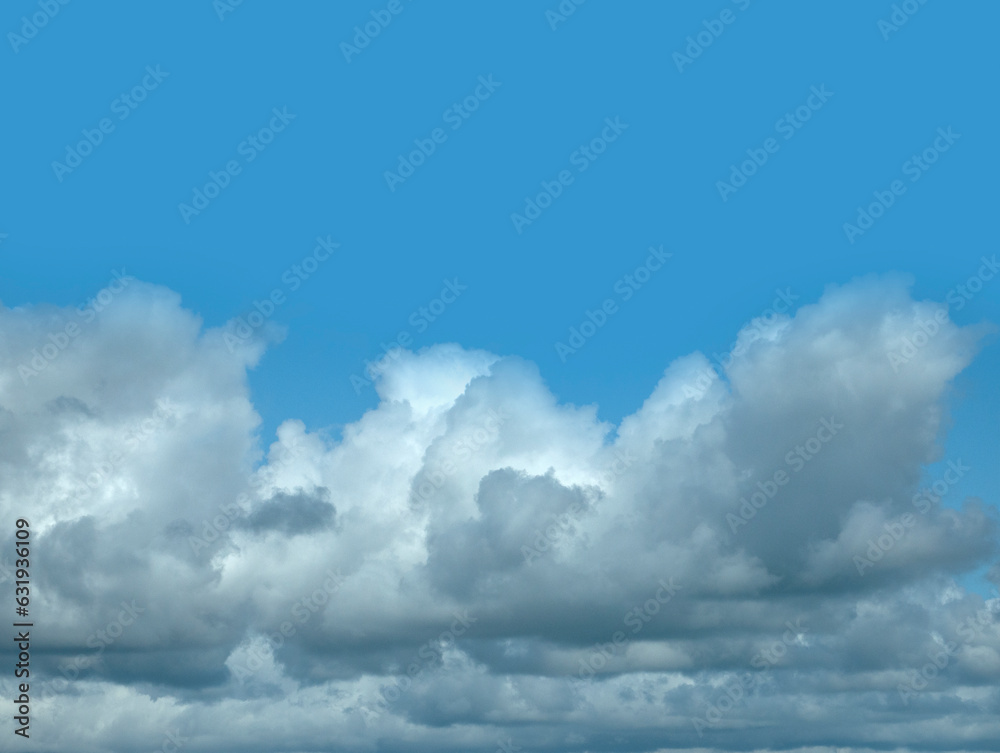 Fototapeta premium White clouds over blue sky background. Fluffy cumulus cloudscape shape