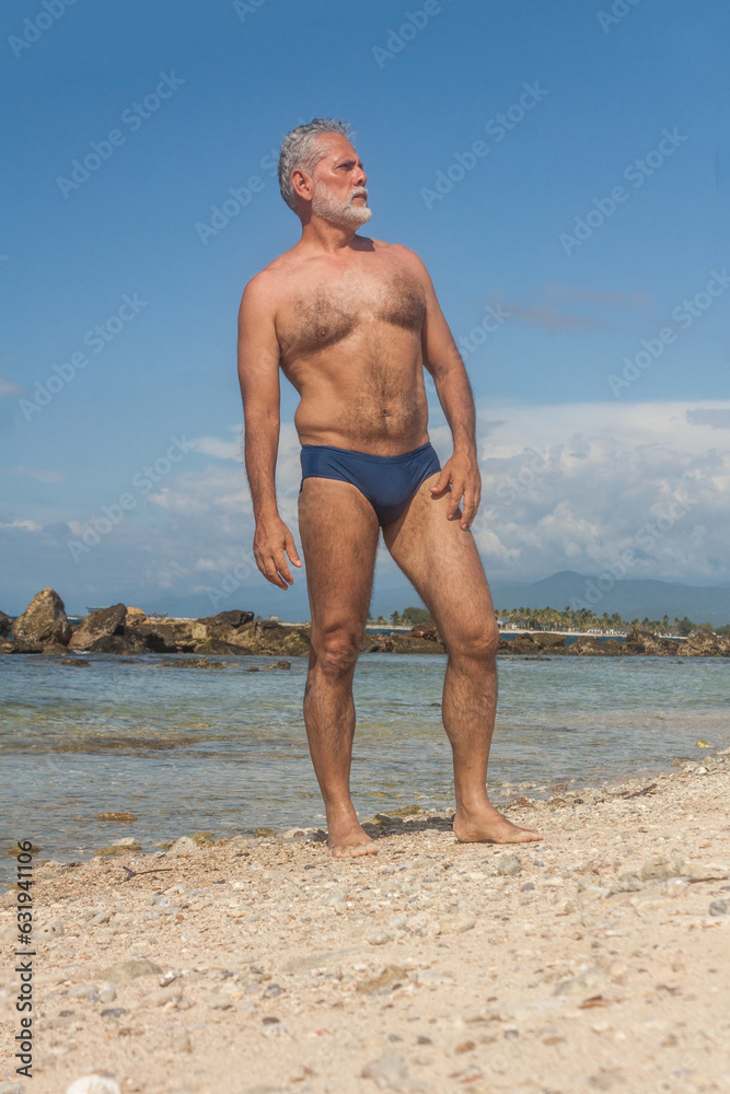 mature man in the tropical beach with blue speedo Stock Photo | Adobe Stock