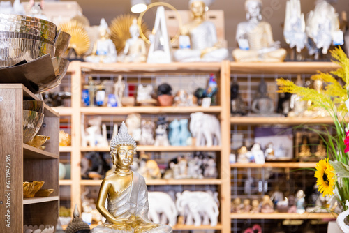 Variety of decorative statues of Buddha at modern shop of home decor goods