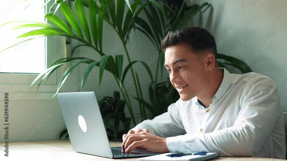Side view handsome young businessman in eyewear working with computer remotely, sitting at wooden table in office. Pleasant happy man communicating in social network, searching information online.
Side view handsome young businessman in eyewear working with computer remotely, sitting at wooden table in office. Pleasant happy man communicating in social network, searching information online.