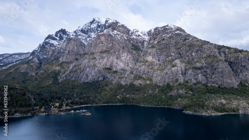 Fototapeta Naklejka Na Ścianę i Meble -  Beautiful chain of snowy mountains and a lake with blue sky above in Bariloche Argentina, amazing panoramic view at Circuito Chico Patagonia