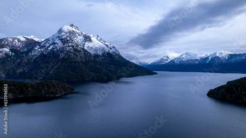 Beautiful chain of snowy mountains and a lake with blue sky above in Bariloche Argentina, amazing panoramic view at Circuito Chico Patagonia