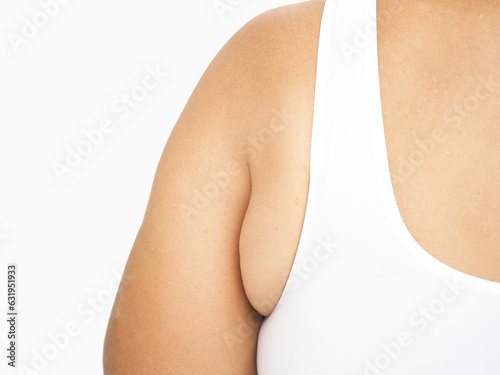 Armpit fat at asian woman between 30-40 years old dressed in a sporty bra. Closeup photo, blurred.