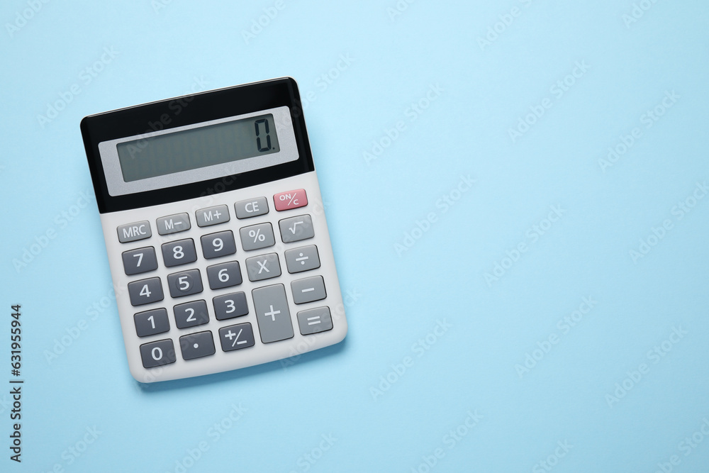 Calculator on light blue background, top view. Space for text Calculator on light blue background, top view. Space for text