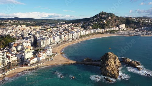 Wallpaper Mural Picturesque drone view of coastal Spanish town of Blanes on bank of Mediterranean coast overlooking port, large sandy beach and Sa Palomera Rock on sunny day, Girona province, Catalonia. High quality Torontodigital.ca