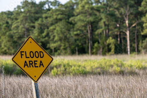 Piney Point, Maryland, USA A Flood Area road sign on a low lying road through marshland.