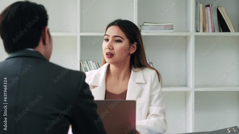 Woman office worker discussing new project with colleague during working day in coworking. Woman office worker discussing new project with colleague during working day in coworking.