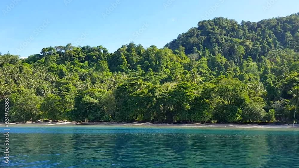 Scenic remote tropical island covered in dense jungle trees and turquoise ocean in Bougainville, Papua New Guinea Scenic remote tropical island covered in dense jungle trees and turquoise ocean in Bougainville, Papua New Guinea