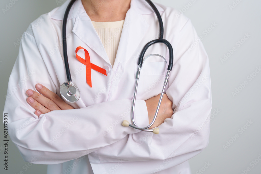 Orange Ribbon for Leukemia, Kidney cancer day, world Multiple Sclerosis, CRPS, Self Injury Awareness month. Healthcare and word cancer day concept Orange Ribbon for Leukemia, Kidney cancer day, world Multiple Sclerosis, CRPS, Self Injury Awareness month. Healthcare and word cancer day concept