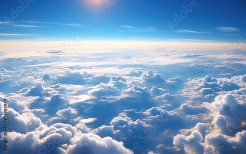 the aerial view of clouds and sky as seen from inside an airplane.