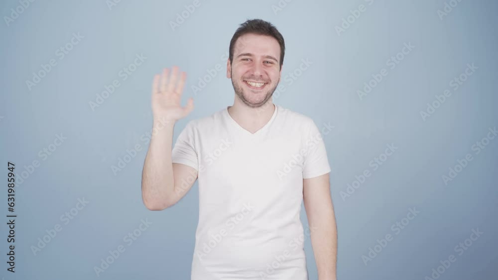 Happy man waving at camera. Happy man waving at camera.