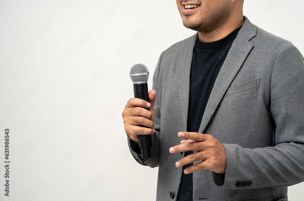 Close up businessman speaker hand holding High quality dynamic microphone and singing song or speaking talking with people on isolated white background. Male testing microphone voice for interview Close up businessman speaker hand holding High quality dynamic microphone and singing song or speaking talking with people on isolated white background. Male testing microphone voice for interview