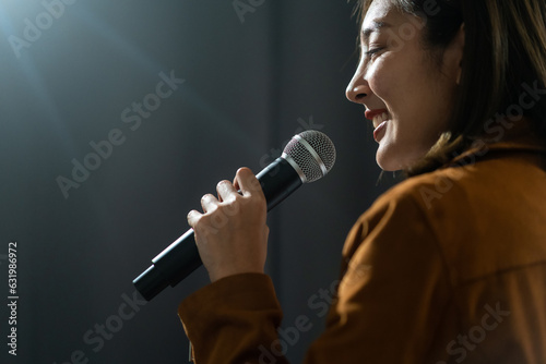 Close up woman hand holding High quality dynamic microphone and singing song or speaking talking with people on isolated white background. Woman testing microphone voice for interview