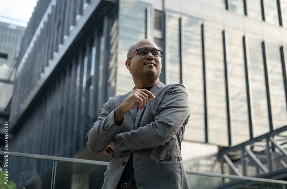 Senior manager business man in suit standing pose at the buildings downtown. Confident man looking towards their goals for success. Executive business man Senior manager business man in suit standing pose at the buildings downtown. Confident man looking towards their goals for success. Executive business man