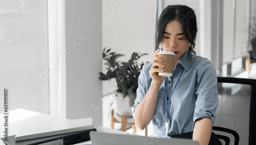 female accountant working on a tablet computer in a modern office. Make an account analysis report. real estate investment information financial and tax system concepts