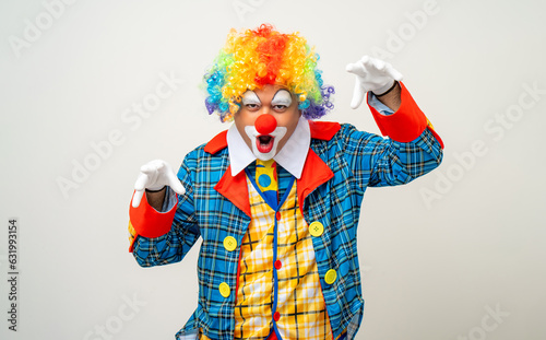 Mr Clown. Portrait of angry psycho mad comedian face Clown man in colorful uniform wearing wig looking camera. Upset stressed serious male bozo in various pose on isolated background.