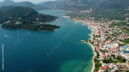 Aerial drone bird's eye view video of iconic port and city of Nidri or Nydri. Harbor for sail boats in Lefkada island, Ionian, Greece photo