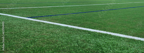 Soccer field texture panoramic background. synthetic grass football pitch empty wide banner with copy space for design