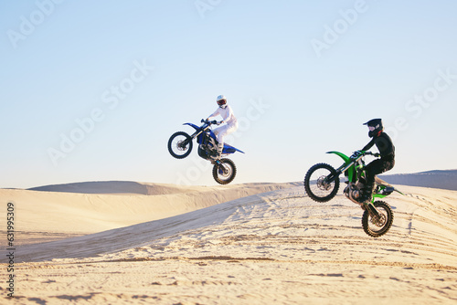 Motorcycle, desert and jump in air, speed and competition at outdoor race for performance, goal or off road. Motorbike athlete, dune and ramp in nature, sand or together for training in mockup space