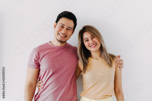 Happy asian Thai couple smiling look at camera, cuddle and hugging with love, new marriage life, isolate over white background.