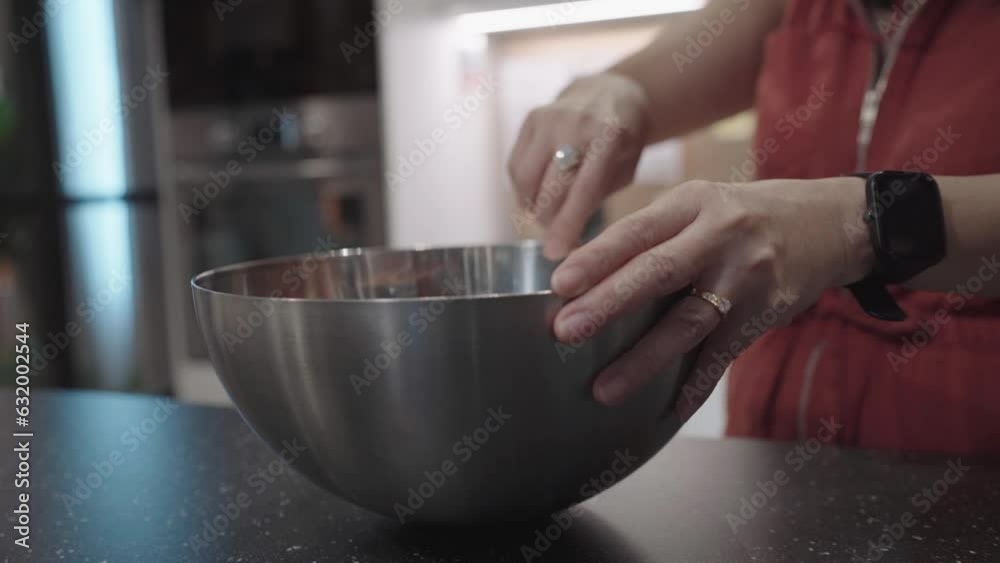 Woman Mixing Flour and Cake Ingredients in Stainless Steel Bowl. Woman Mixing Flour and Cake Ingredients in Stainless Steel Bowl.