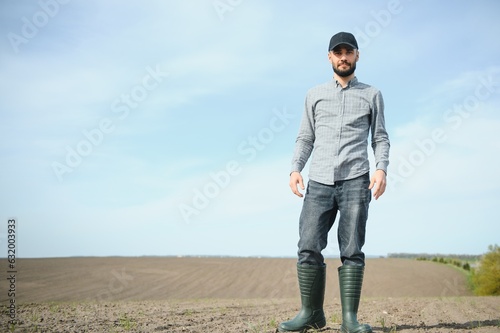 Portrait of farmer standing in field. © Serhii