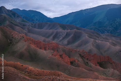 Tract Zhaman uy in the mountains of Kazakhstan on platey Assy. Fantastic clay remains of red color on summer evening © Lana Kray