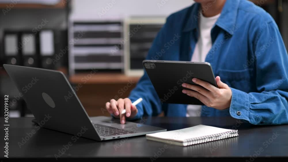 Businesswoman s hands typing on smartphone, tablet and laptop keyboard computer, typing, online in modern office Businesswoman s hands typing on smartphone, tablet and laptop keyboard computer, typing, online in modern office