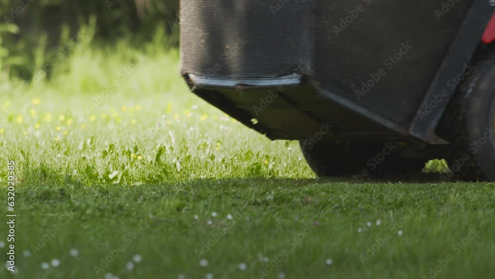 Close Up Lawnmower On The Spring Grass Field In The Yard. Close Up Lawnmower On The Spring Grass Field In The Yard.