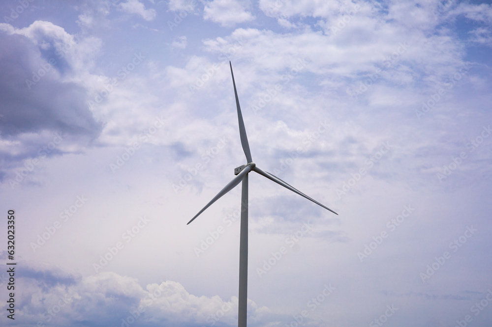 Wind Turbine Behind the beautiful blue sky Wind Turbine Behind the beautiful blue sky