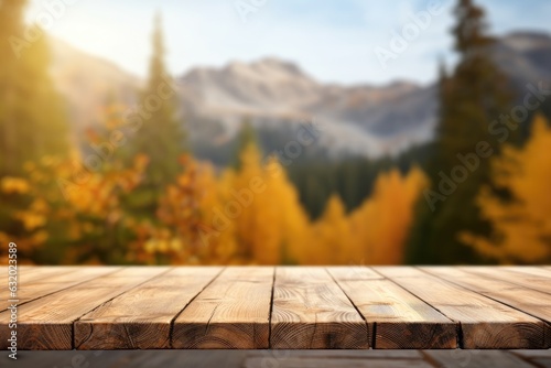 Wooden table top on blurred background of autumn color landscape in dolomites - for display your products