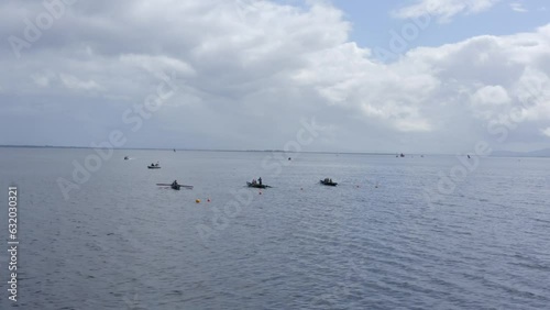 Aerial orbit above currach boats tethered to buoys in galway bay photo