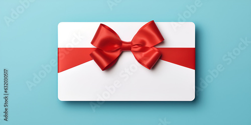 Pink gift box with red bow and ribbon on blue paper background with empty place for text. © Hadi